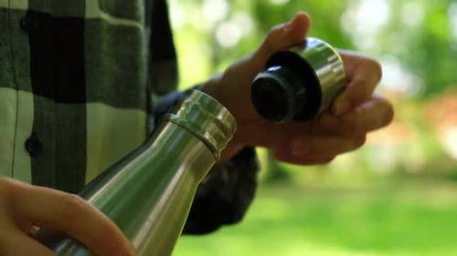 Closeup of Unrecognizable Female Hand Holding Water Bottle