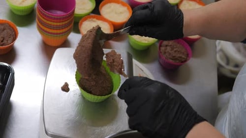 Pastry Chef Scoops Delicious Batter Into Cupcake Paper