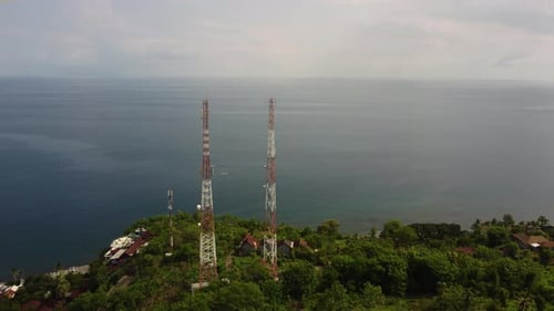 two aerial 5g telecom tower data internet wireless gsm gps 4g social media with ocean view . conspir