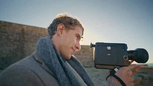 Man Shoots with Vintage Camera near the Sea