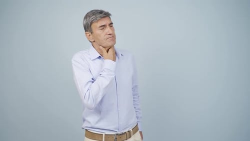 Man With Sore Throat in Studio Setting