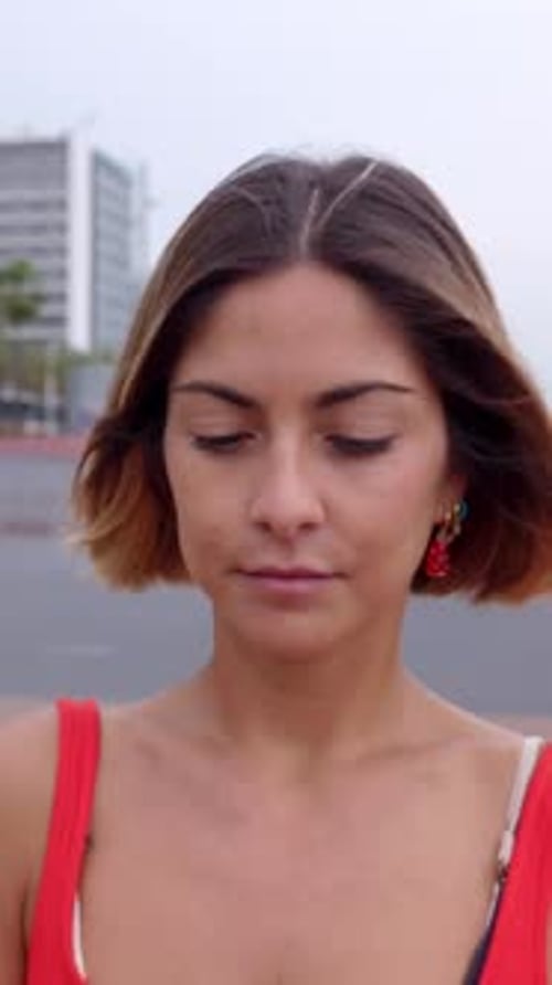 Young Blonde Beautiful Woman Using Cell Phone Walking in the Street