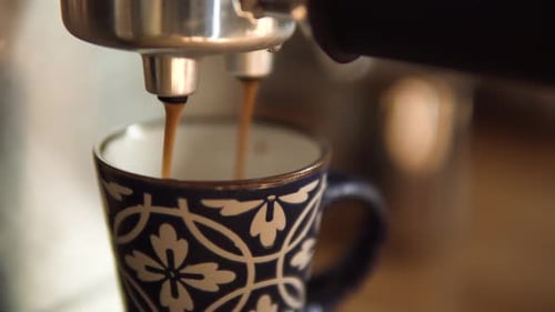 Espresso Machine Filling Blue Patterned Mug Close Up