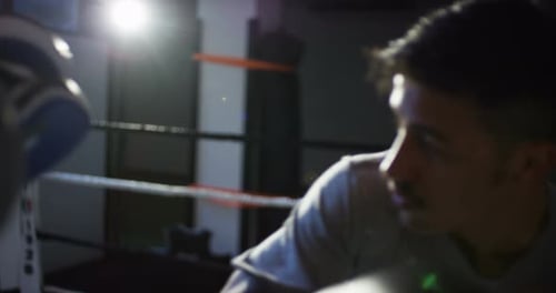 Focused Boxer Sparring in Gym Training Ring
