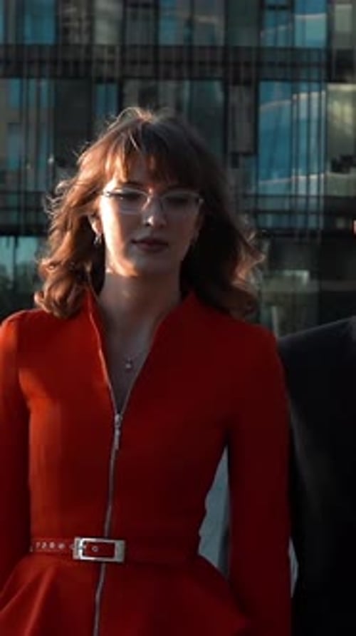 Stylish Businesswoman Walking With Businessman in Urban Setting