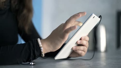 Young Woman Using a Tablet Device Indoors