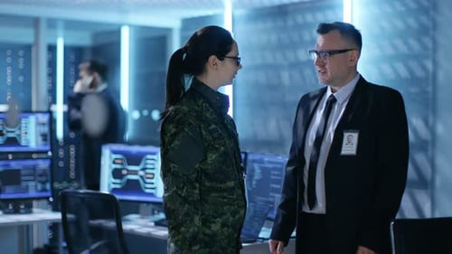 Government Official Talks To Female Army Officer. In the Background Busy System Control Center with