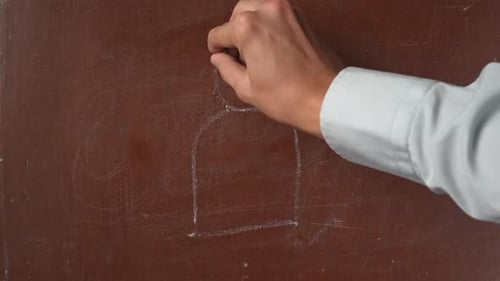 Hand Drawing Person with Question Marks on Chalkboard
