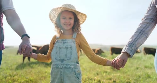 Farmer, family and girl with parents at cattle farm, holding hands and learning about livestock