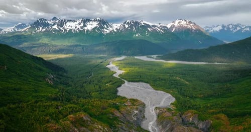 Approaching the beautiful green valley in the mountains crossed by the river.