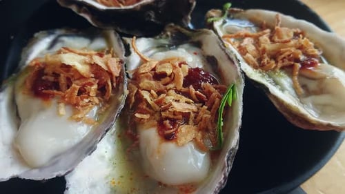 Fresh Oyster Thai style with spicy seafood sauce. serve with Chili paste, crispy shallots, garlic.