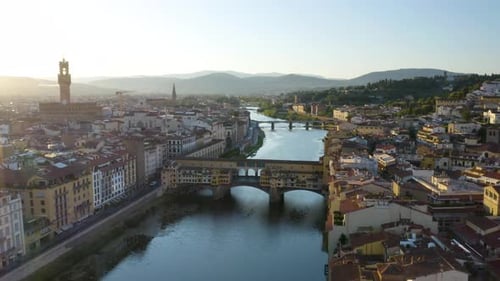 Low Drone Flight Over Ponte Vecchio Bridge at Sunrise in Florence. Arno River