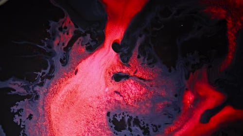 Glowing red and black fluids swirling in abstract chemical reaction scene