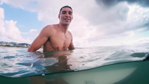 Shirtless Man Giving Hang Loose Gesture in the Ocean