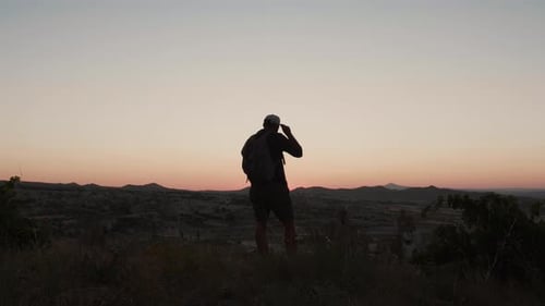 Wanderlust Concept Silhouette of Happy Young Tourist Man Hiking with Backpack Enjoying Mountain