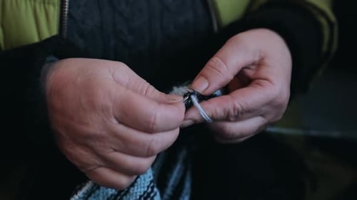 Woman Knitting with Yarn and Needles