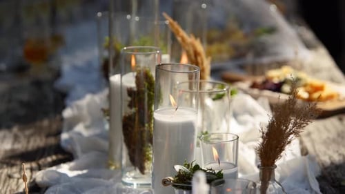 Wedding Party Banquet Outdoors in Forest Dining Table Decorated in Boho Style with Candles White