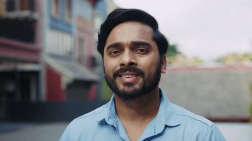 Portrait of Confident Indian Man Smiles Looking in Camera on Street Closeup