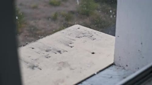Rain Falling Outside a Window on a Cloudy Day
