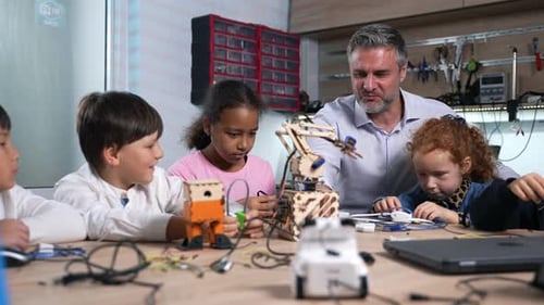 Children Learning Robotics with Instructor in Workshop