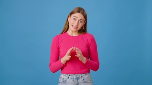 Indecisive Female Connecting Fingers and Shrugging in Studio