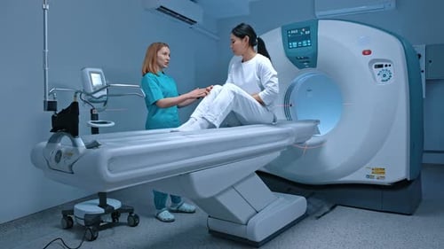 Woman in CT Scanner Examined by Nurse