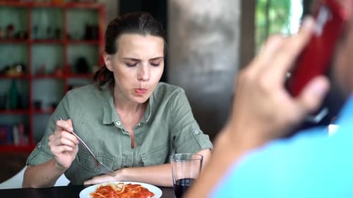 Woman Eating Lunch While Talking on Phone