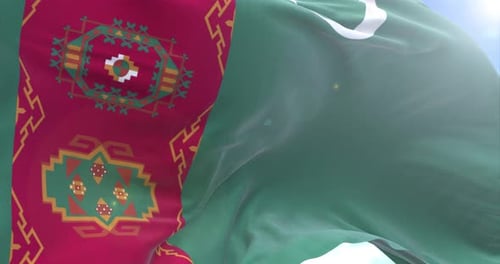 Waving Turkmenistan Flag Against Blue Sky