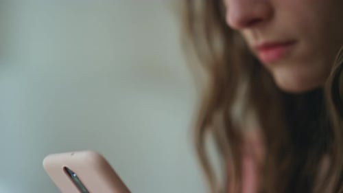 Closeup Hands Holding Smartphone in Dark Room Worried Girl Looking Screen Read