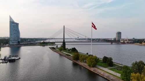 Luftaufnahme des Flusses Daugava und der Vansu-Brücke in Riga am frühen Morgen bei Sonnenaufgang auf klarem Himmel
