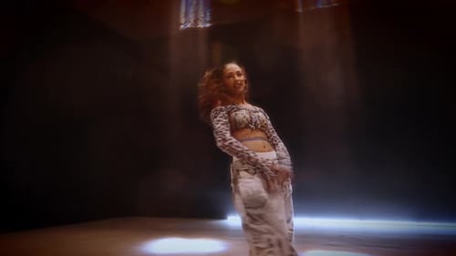 Woman Energetically Dances In A Studio With Matrix Beam Lights