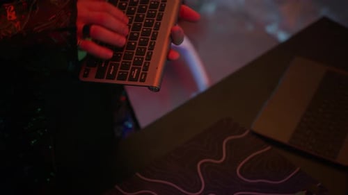 Mann im VR-Visier entschlüsselt Daten auf dem Computer mithilfe der Tastatur im Cyberpunk-Raum
