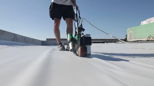 Roofer Working on White Tarp Roof