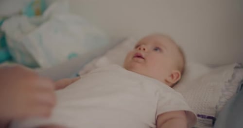 Adorable Infant Lying on Changing Table Indoors