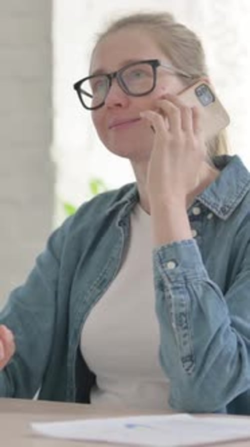 Beautiful Young Woman Talking on Phone in Office, Vertical Video