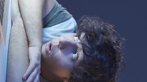 Young Adult Leaning with Curly Hair Looking Around