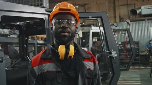 Black Male Worker Giving Excursion around Industrial Plant