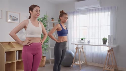Two Women Exercising Together Indoors