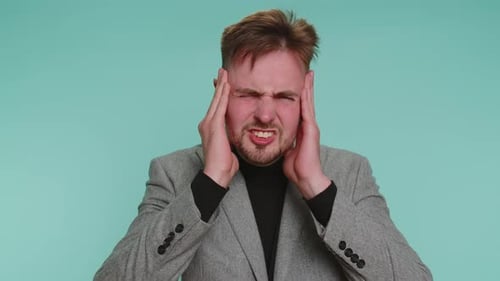 Young Adult Man Suffering from Headache Pain
