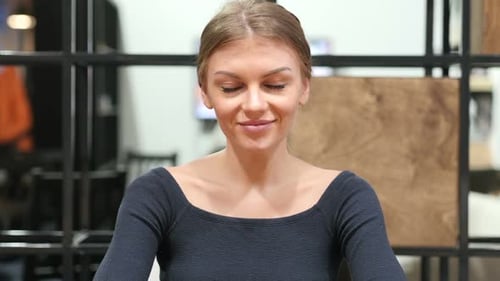 Smiling Young Woman With Blonde Hair in Office