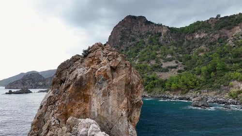 Dramatic Color of the Sea Waves Crashing Against the Rocks Aerial View on a Wild Beach