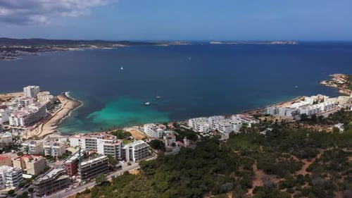 Aerial drone footage of the town of Sant Antoni de Portmany on the west coast of Ibiza in Spain