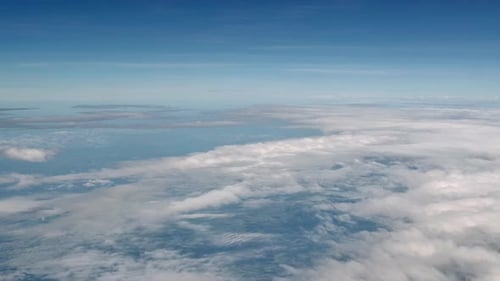 Aerial Cloudscape with Blue Sky and Puffy Clouds