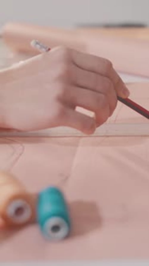 A Person is Drawing a Pattern on a Piece of