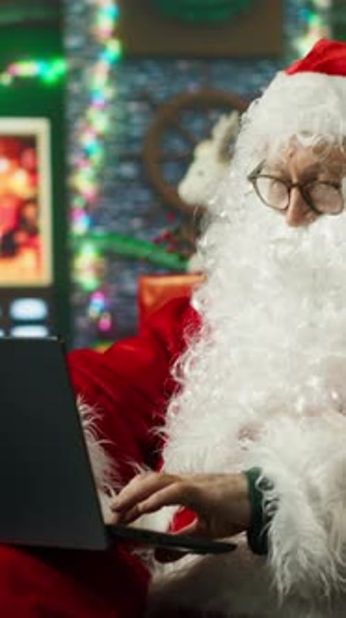 Santa Claus Typing on a Computer at Desk