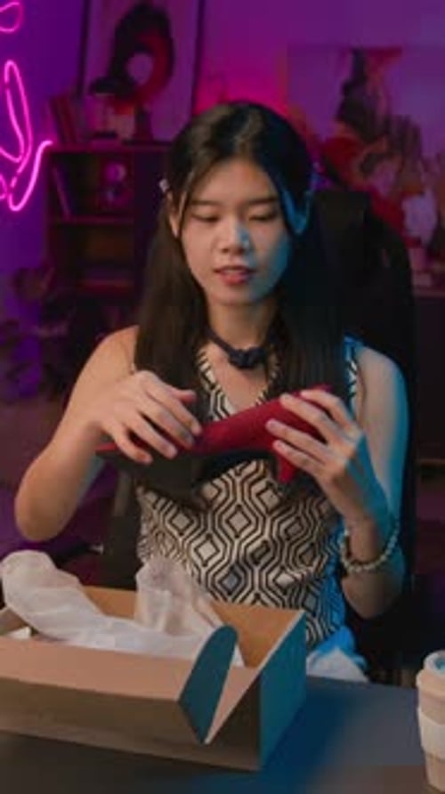 Woman Unboxing a Red High Heel Shoe