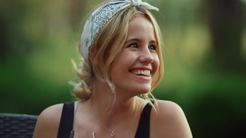 Woman talking with friend outside in garden setting