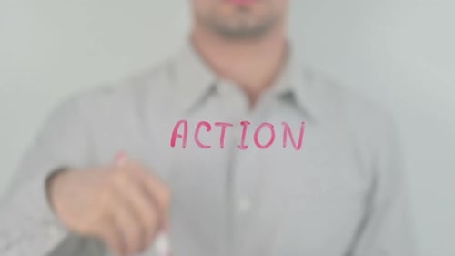 Hand Writes Action with Marker on Glass