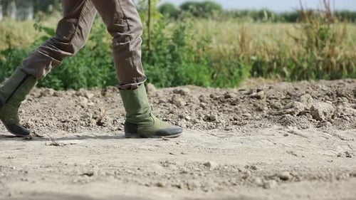 Legs Walking on a Dirt Road in Rural Area