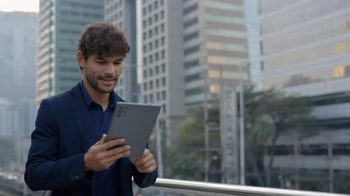 Portrait of Hispanic Businessman Uses Digital Tablet Smiling on City Street